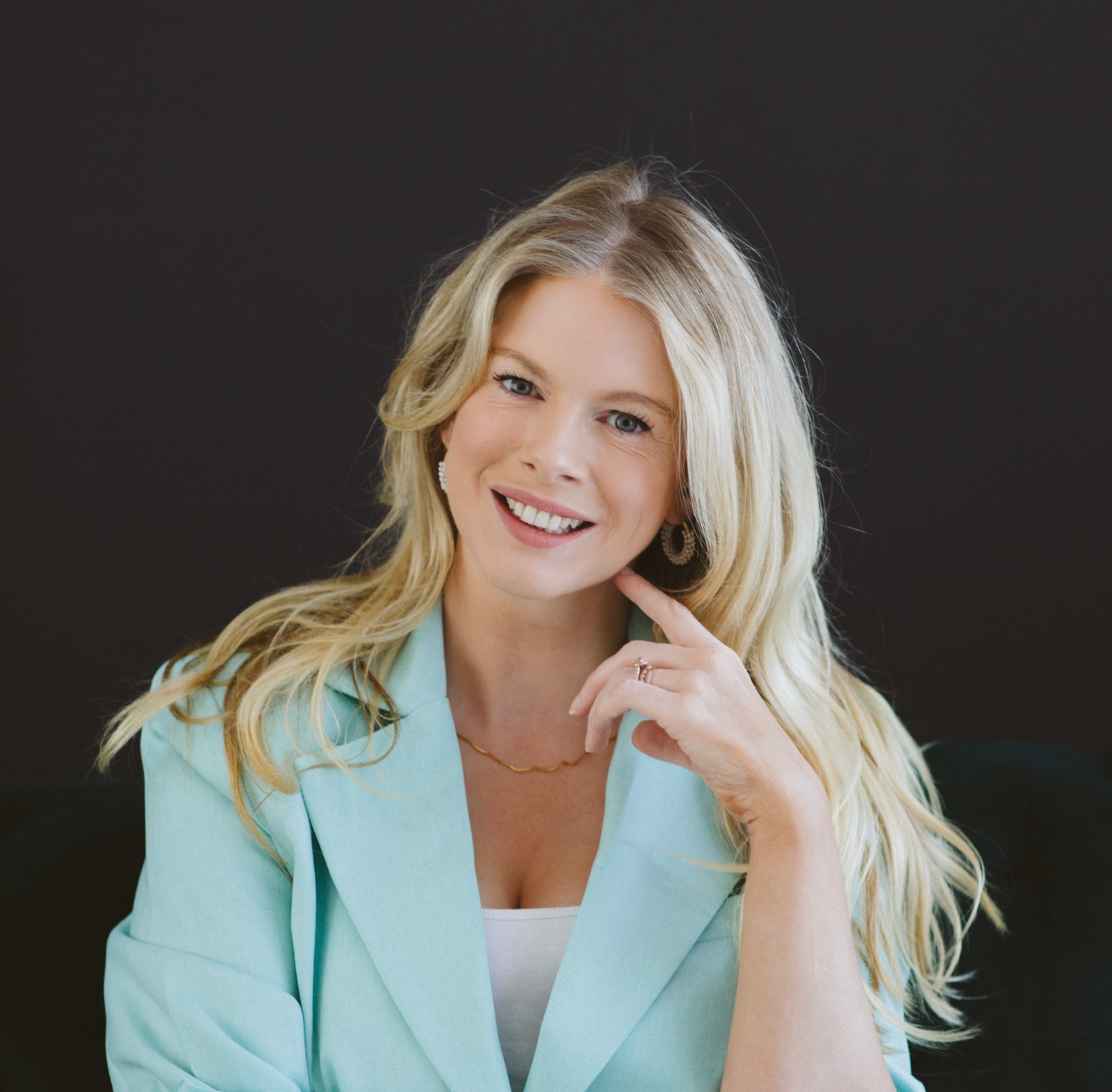 Beth Clay, founder of Financed Well, in a mint blazer